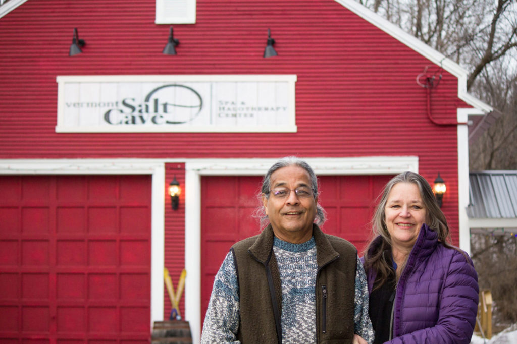 Owners of Vermont Salt Cave stand outside in front of their red barn in Montgomery